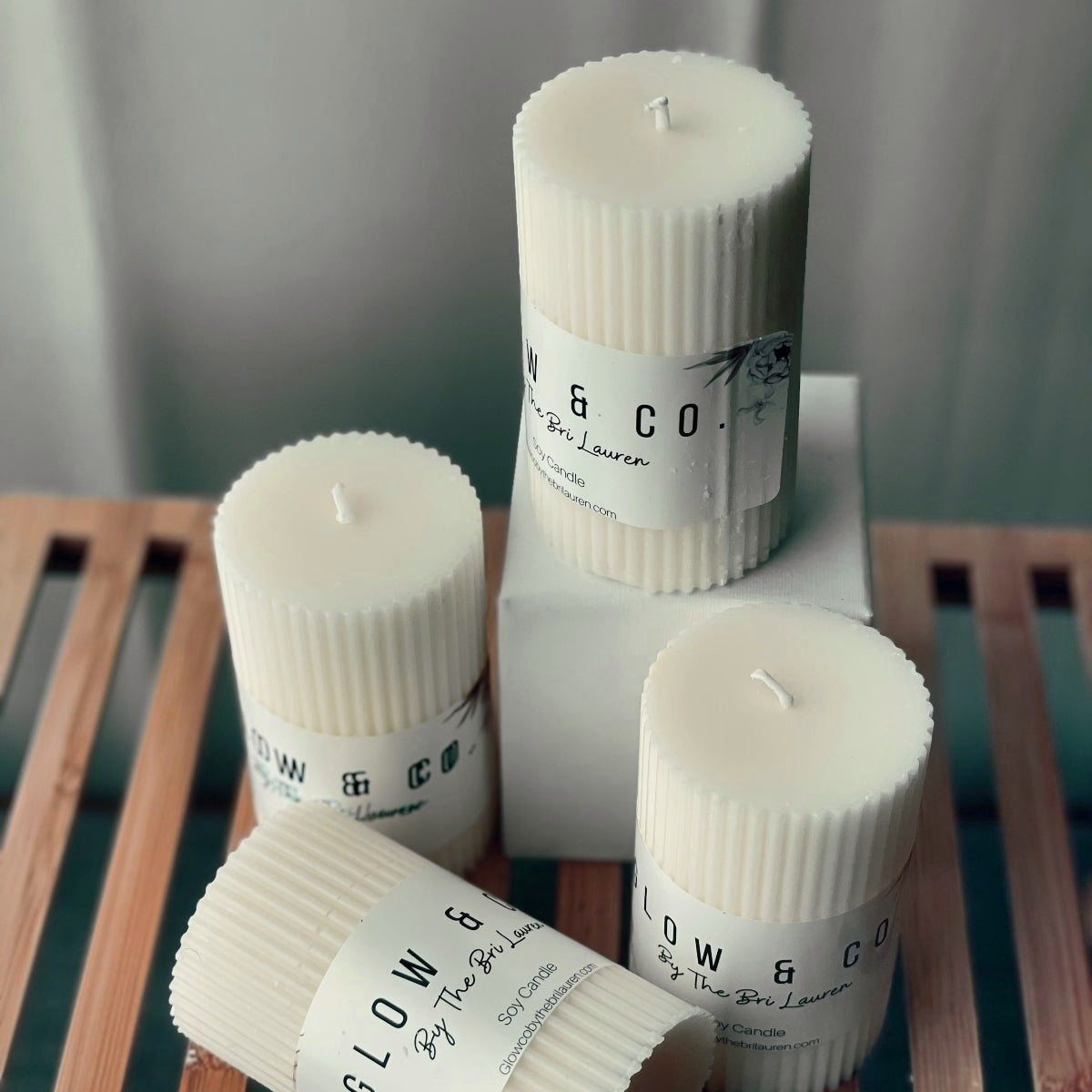Group of White Pillar Candles on a bamboo rack