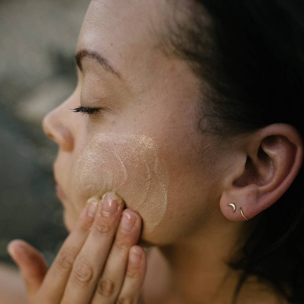 Woman washing her face with the Goji Nectar Cleansing Balm
