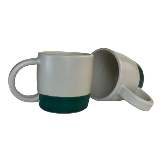 Petite ceramic mugs in soft white with a green border