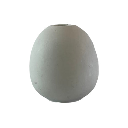 An egg shaped minimalist concrete bud vase