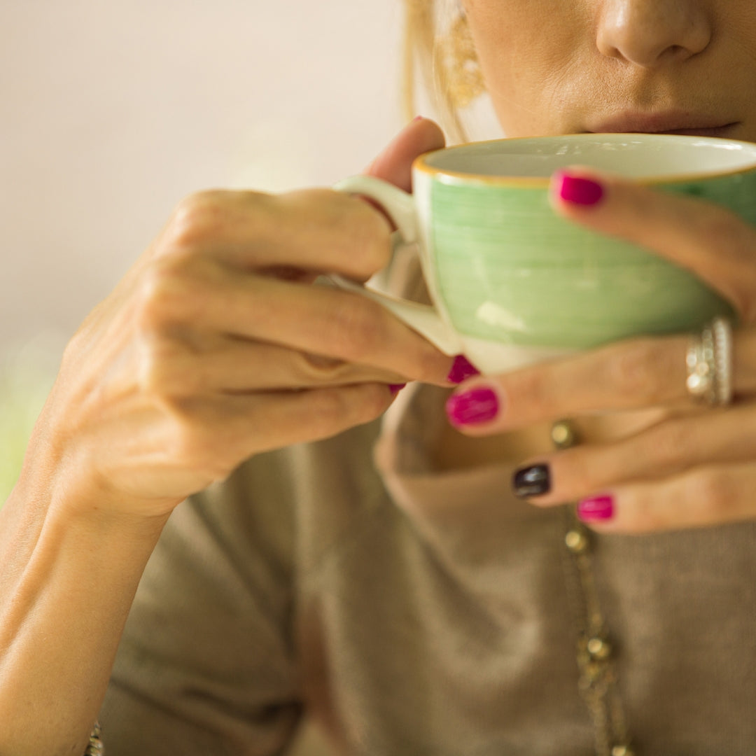 Woman sipping hot cocoa in her empty nest