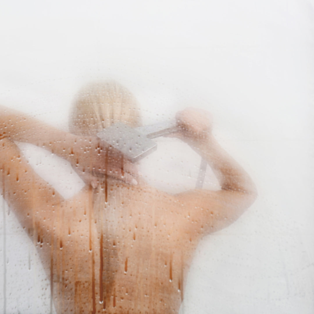 Woman showering with eucalyptus spray and soap