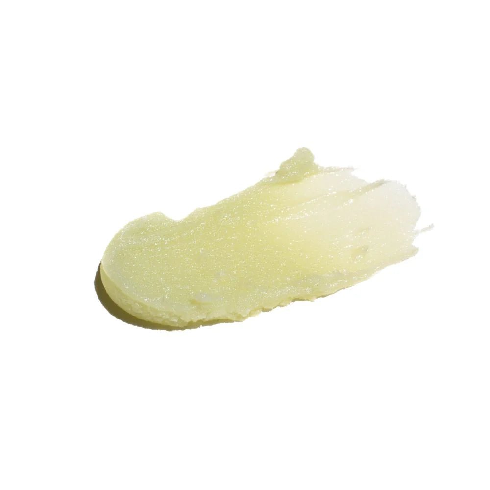 A smear of the Goji Nectar cleansing balm revealing it's avocado green color and creamy balm texture