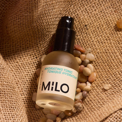 Bottle of hydrating tonic from MILO Multifunctional on a burlap bag with pebbles
