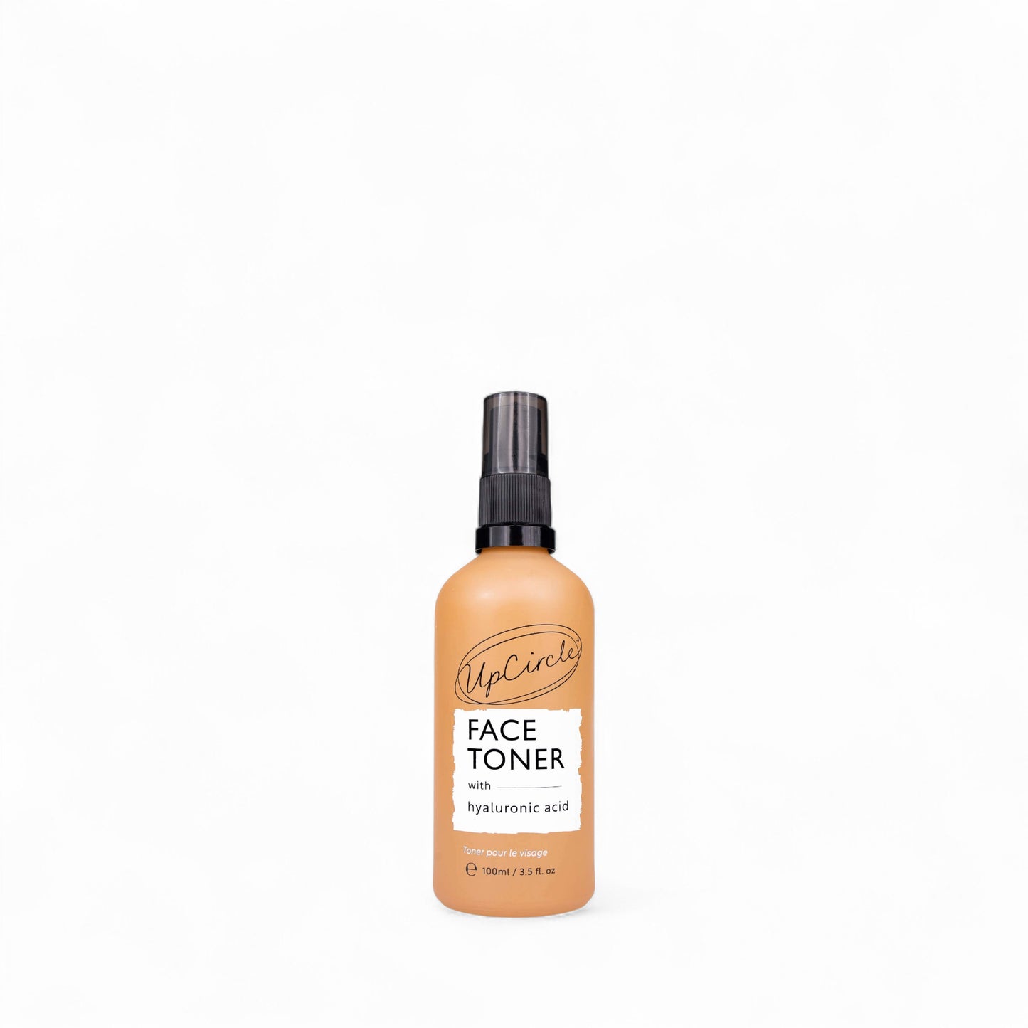 Glass spray bottle of face toner with hyaluronic acid from UpCircle on a white background