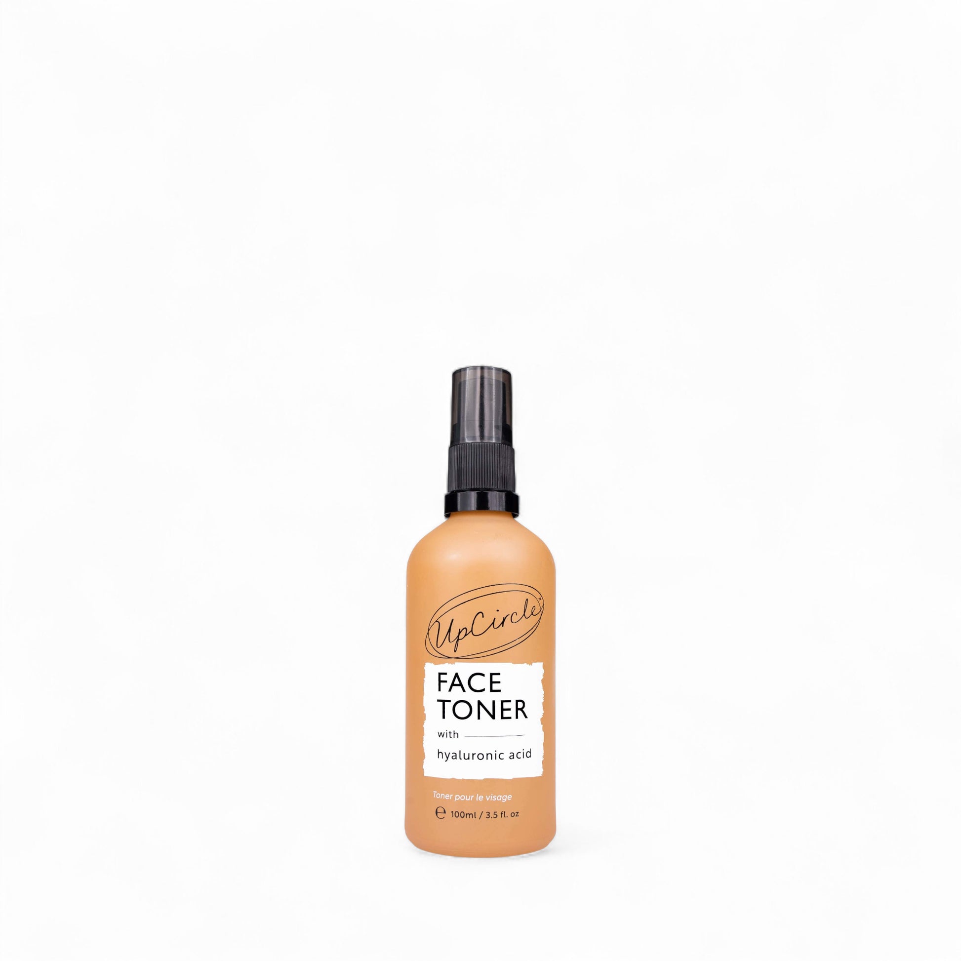 Glass spray bottle of face toner with hyaluronic acid from UpCircle on a white background