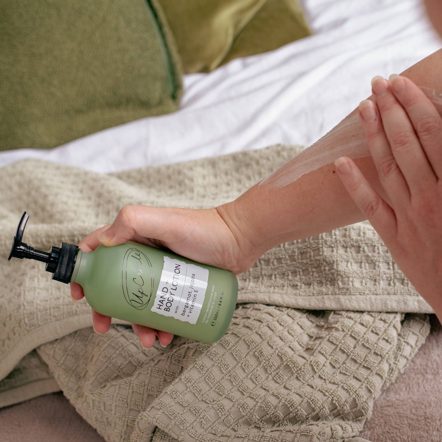 Person applying a light and refreshing bergamot body lotion on their arm.