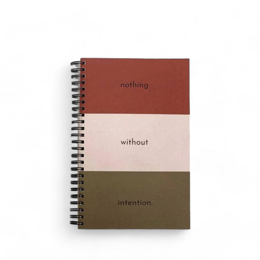 Intention Journal with bold color blocks that says "nothing without intention"