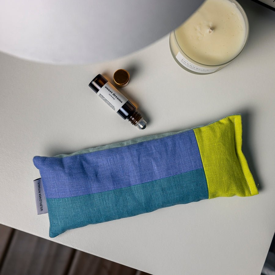 Weighted Eye Pillow on nightstand with aromatherapy and candle