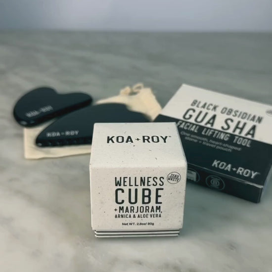 Woman demonstrating use of the Wellness Cube with the Gua Sha. 