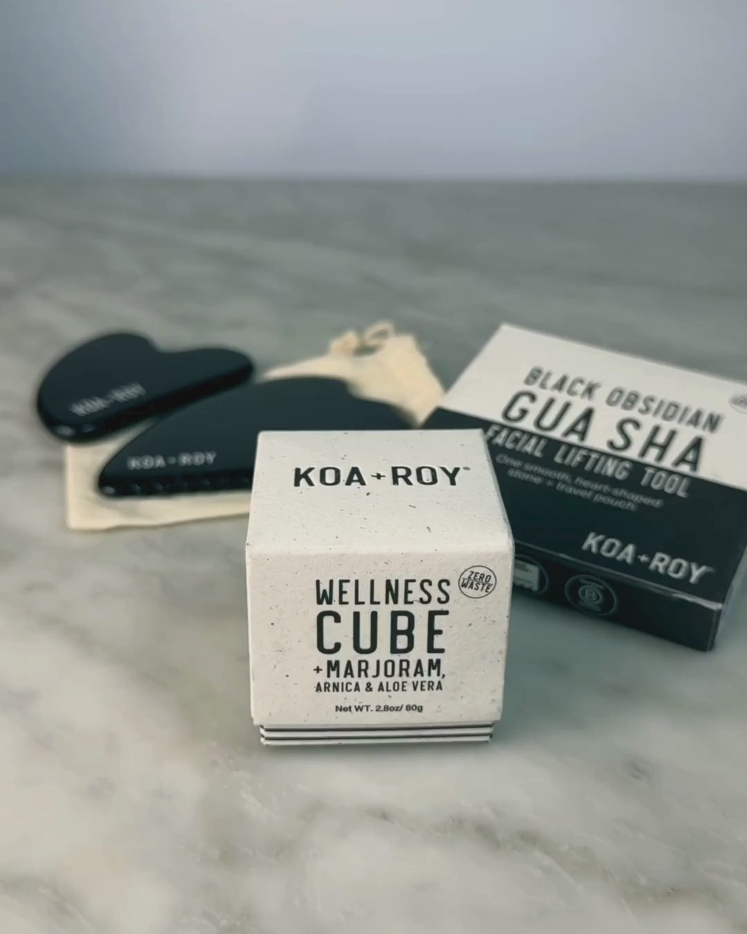 Woman demonstrating use of the Wellness Cube with the Gua Sha. 