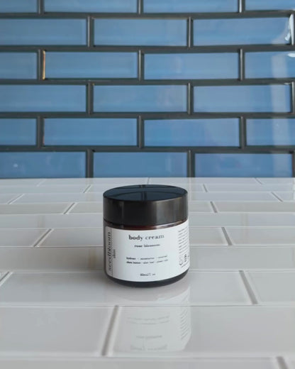 Video of woman opening jar of floral body lotion