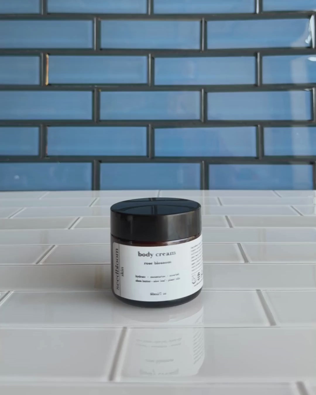 Video of woman opening jar of floral body lotion