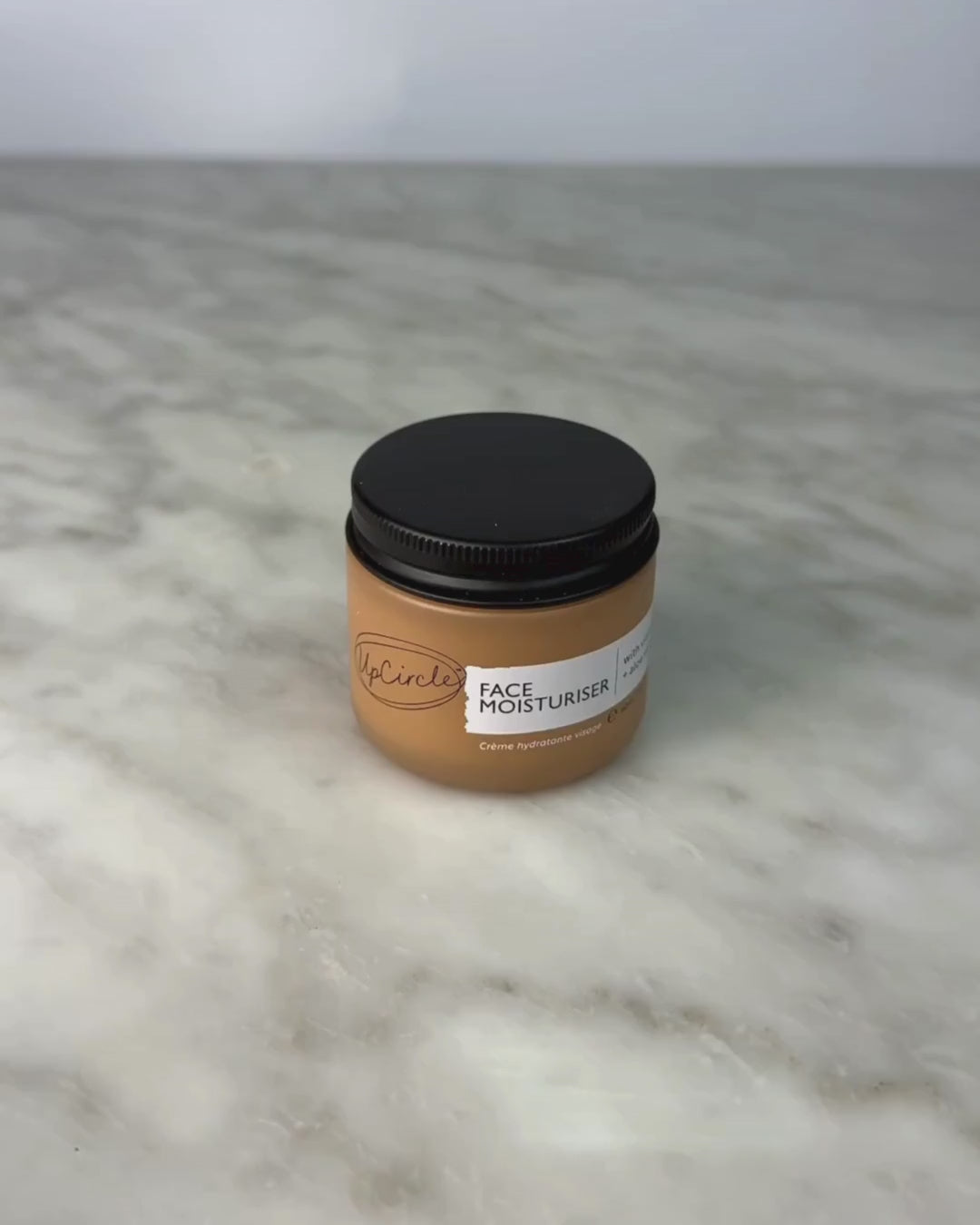 Video of woman opening jar of the UpCircle Face Cream