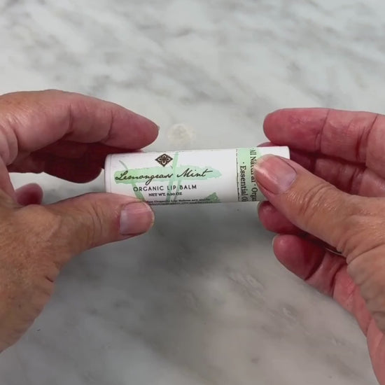 video of woman opening the Lemongrass Mint Lip Balm from Unearth Malee