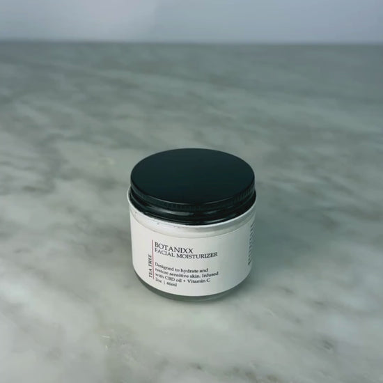 Woman opening jar of Tea Tree + Vitamin C Face Cream