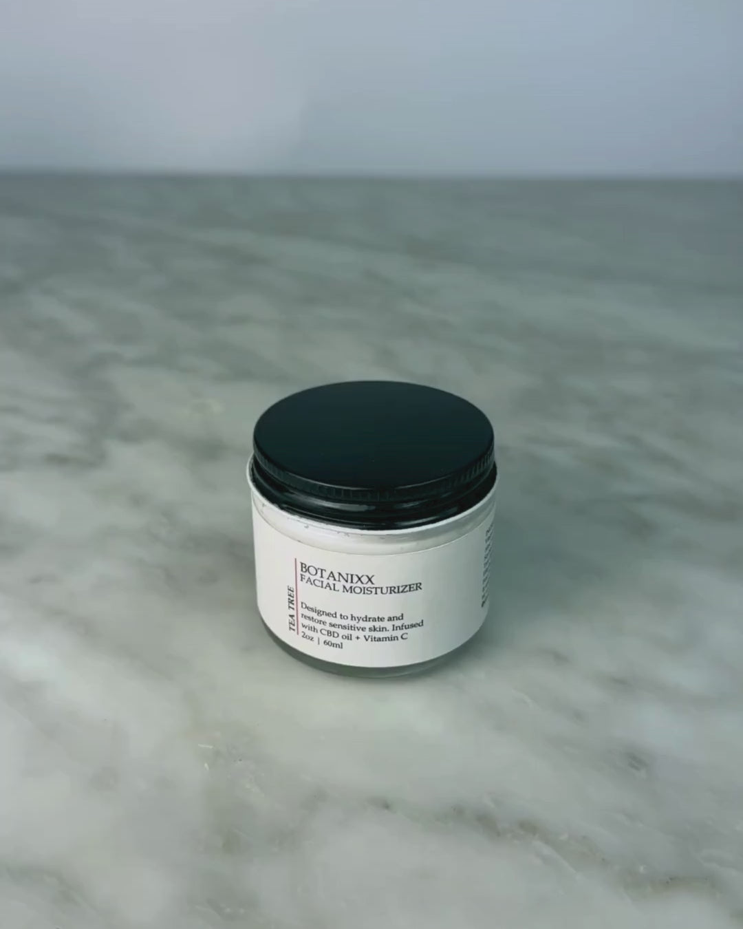 Woman opening jar of Tea Tree + Vitamin C Face Cream