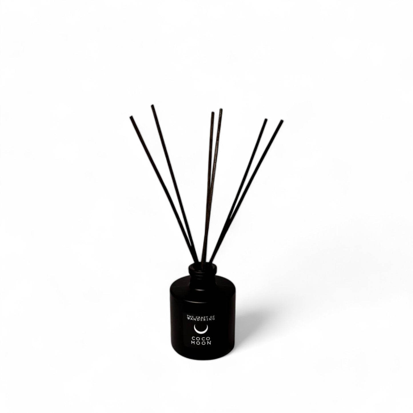 Coco Moon diffuser with reeds on white background