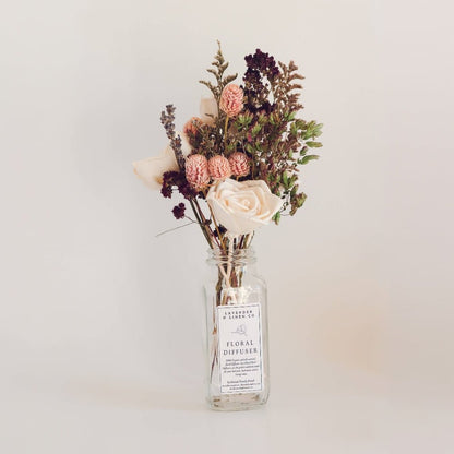 Jar of floral diffuser with dried flowers and sola reeds