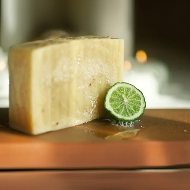 Handmade Thai Lime and Rosemary soap on a counter with lime