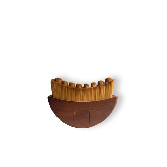 Gua sha brush made of solid American walnut wood for facial lymphatic drainage.