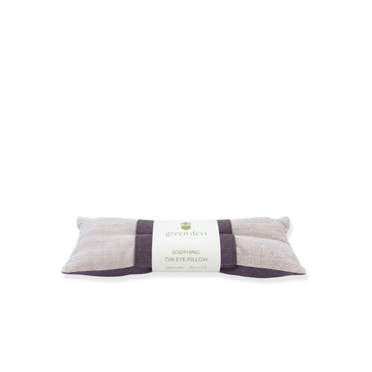 A Green Devi Soothing Obi Eye Pillow in lavender and natural linen, wrapped in a paper label, on a white background.