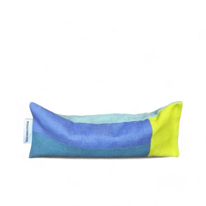 A linen eye pillow in bright blue and yellow fabric