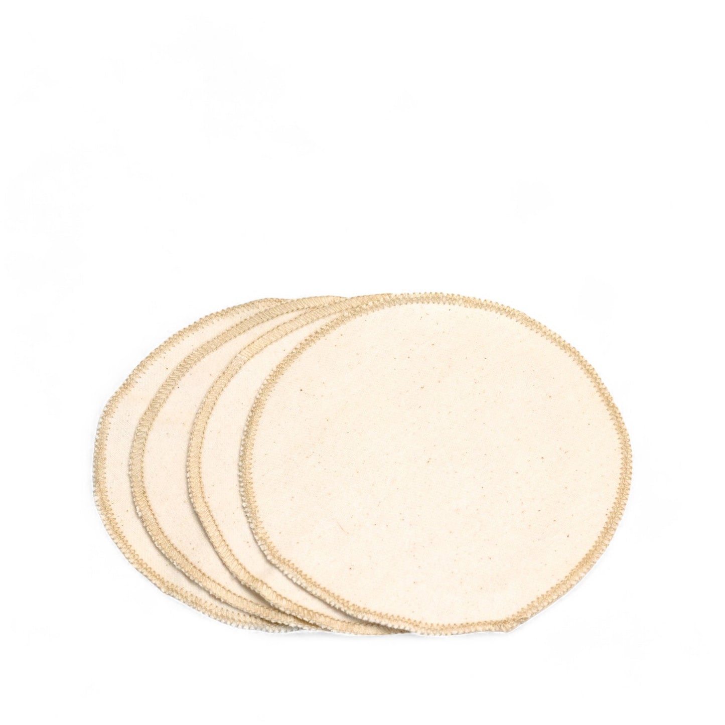 Set of four round reusable face cloths on a white background