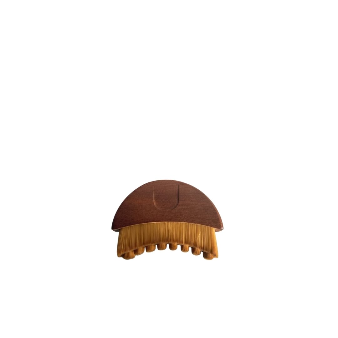 Gua sha brush made of solid American walnut wood for facial lymphatic drainage.