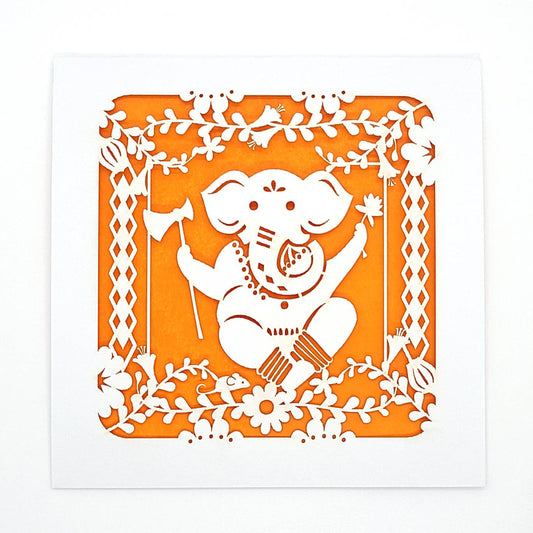 Greeting card with a laser cut design of the god Ganesha on white with an orange background 