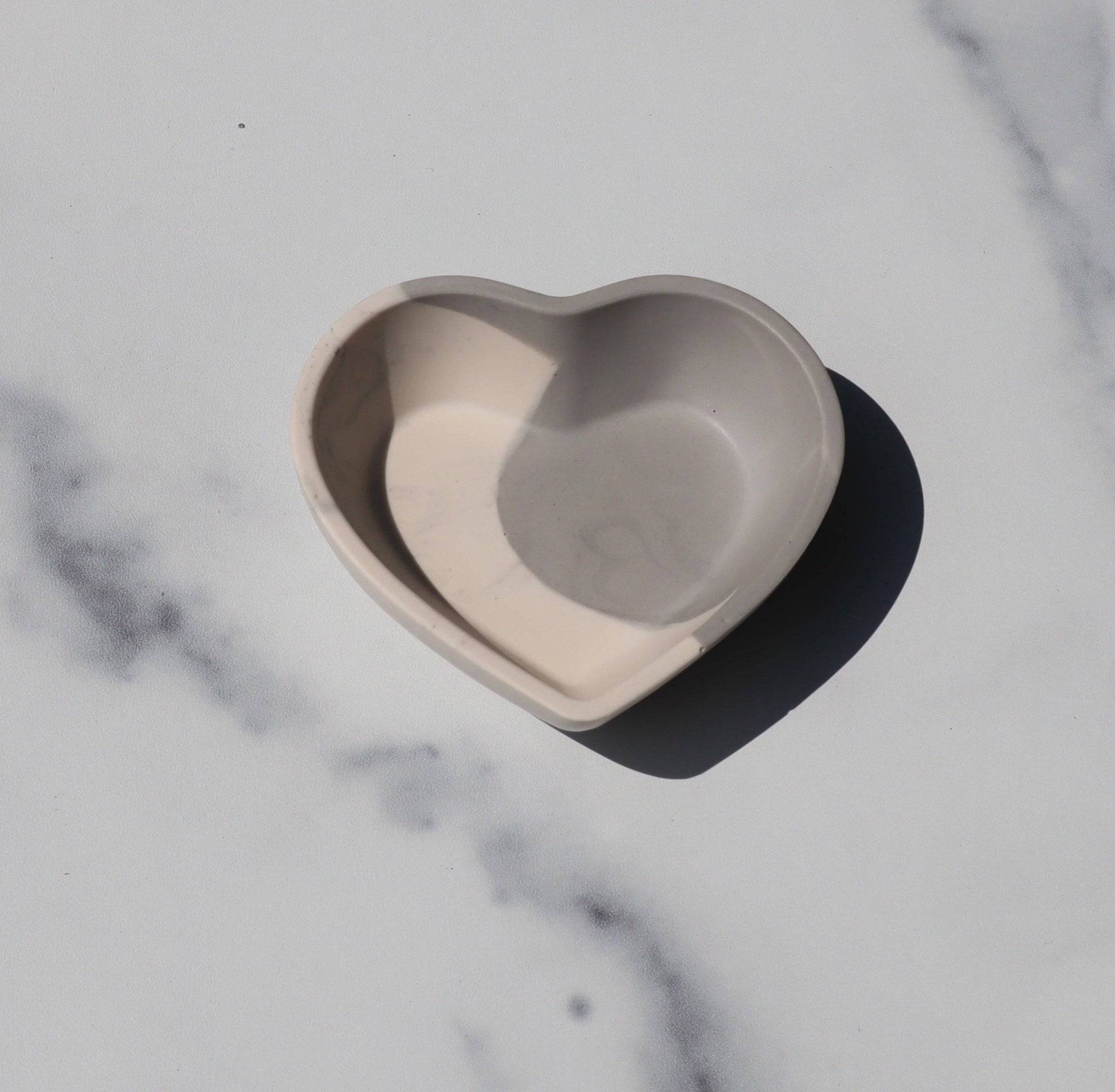 Small heart shaped dish on a marble counter