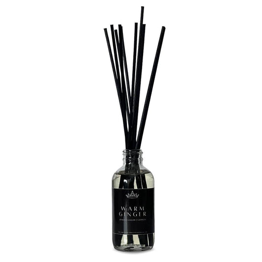 A diffuser bottle of Warm Ginger aromatherapy with black reeds 