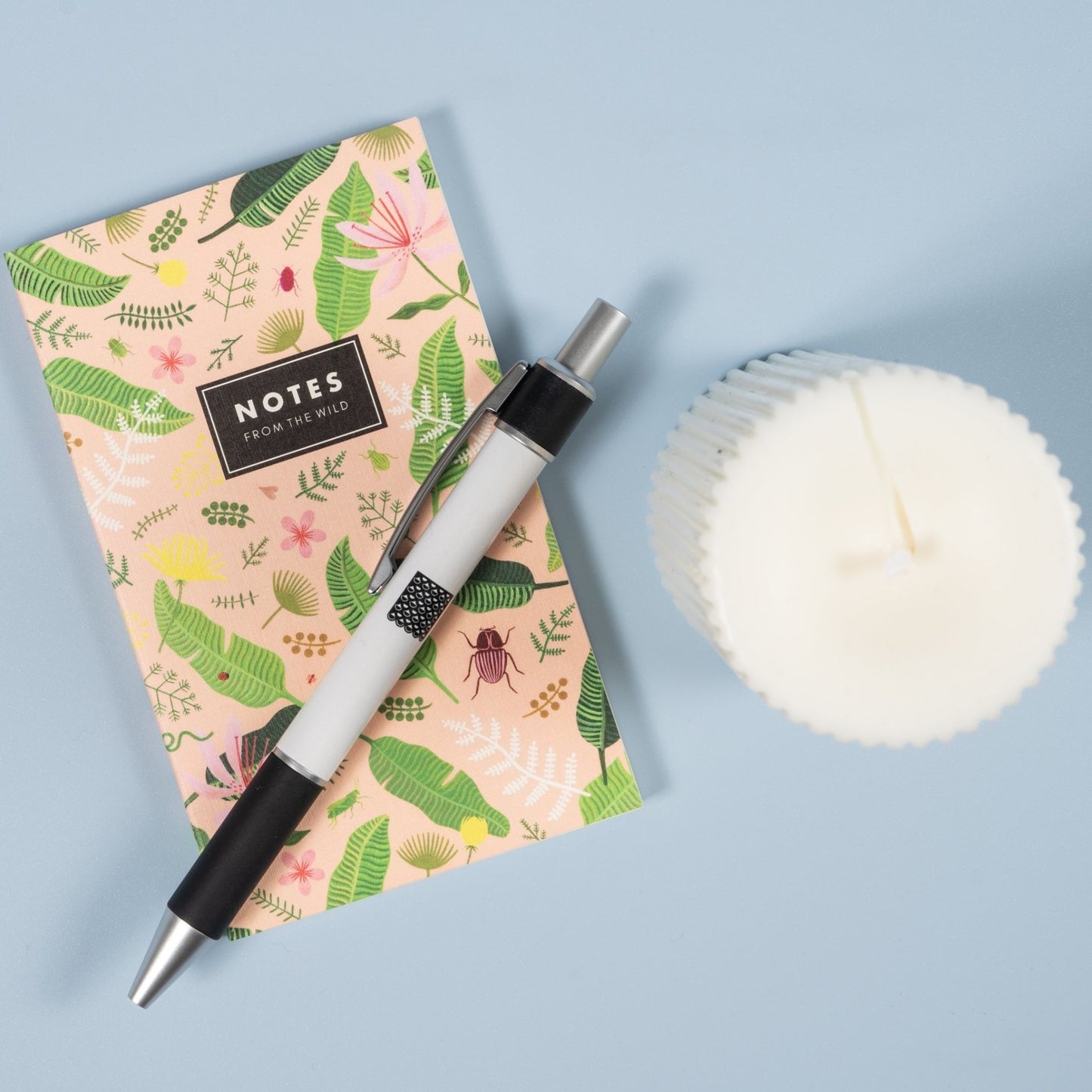 Mini notepad with a pen and candle
