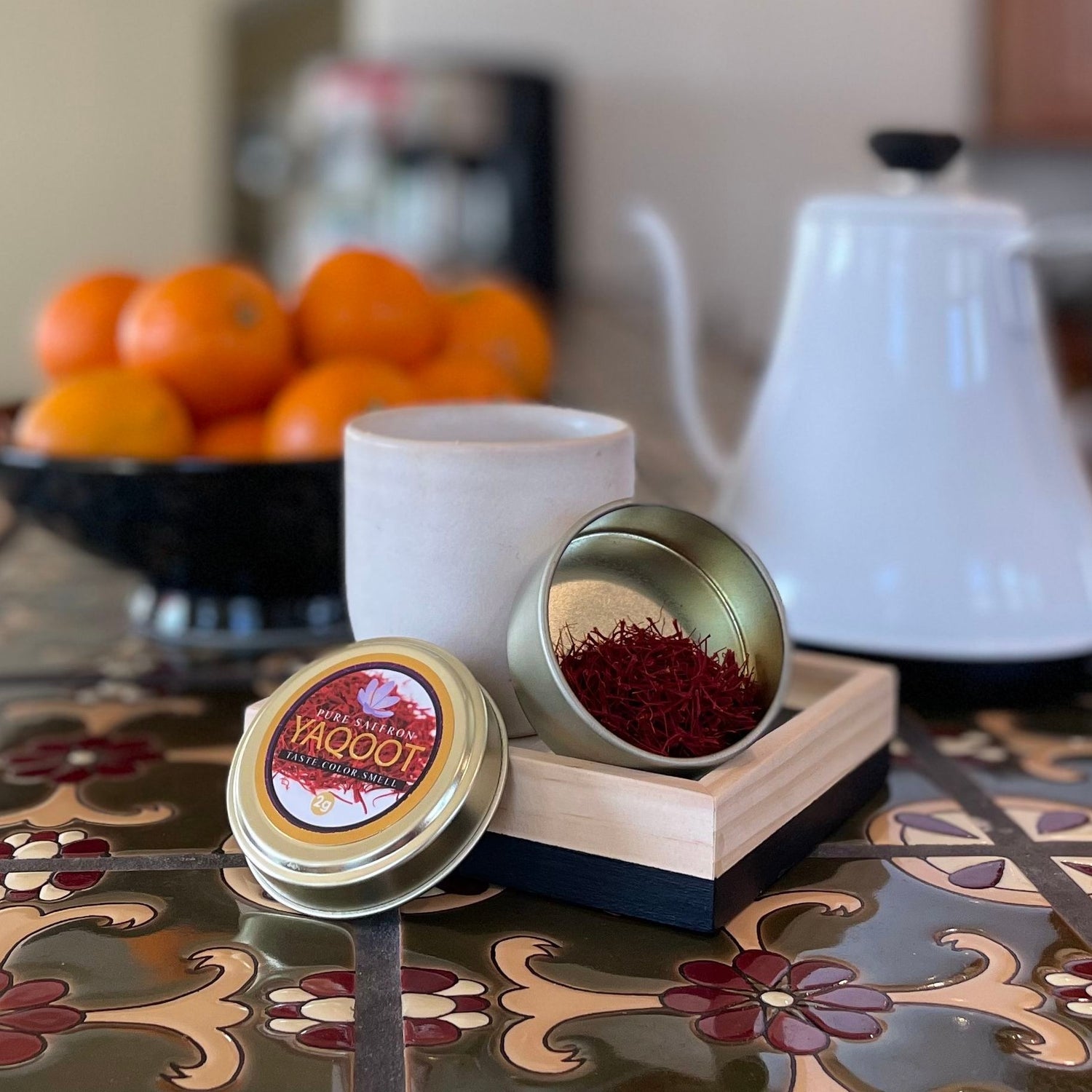 Organic Premium Saffron on counter with oranges and tea kettle in background