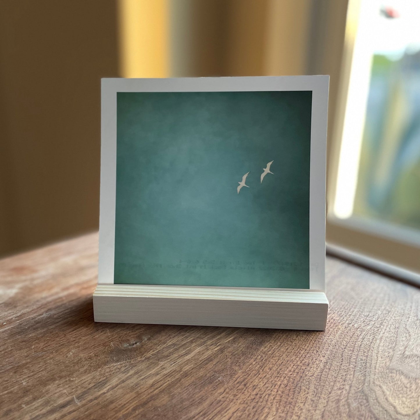 Photo Holder Stand with an art photo of two white birds on a blue background