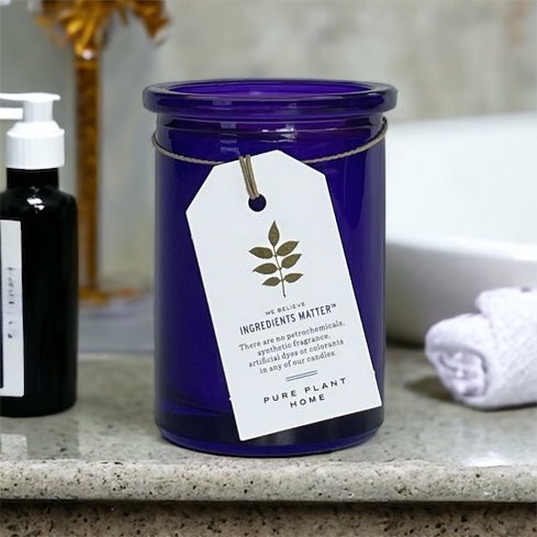Wildcrafted French Lavender Wellness Candle next to a bathroom sink